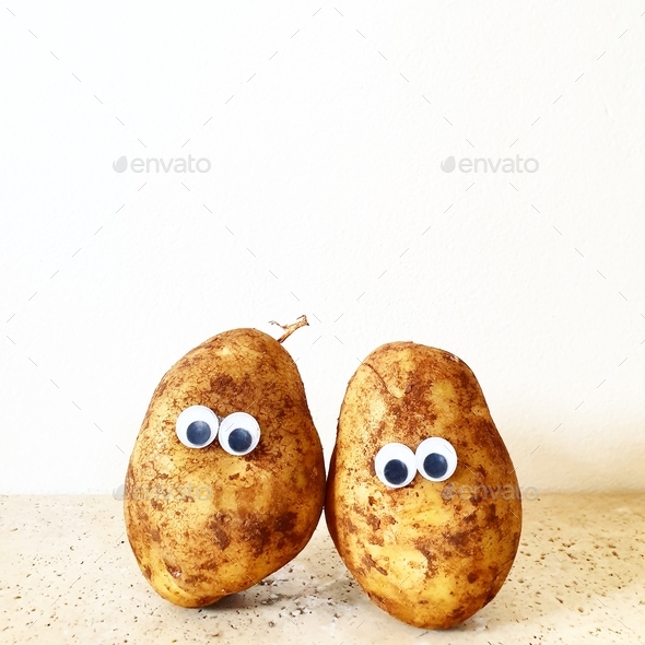 potato with googly eyes on white background with space for text Stock Photo by Angela_Sikiric