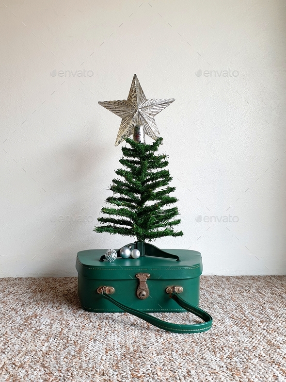 Christmas tree on top of vintage suitcase Stock Photo by Angela_Sikiric