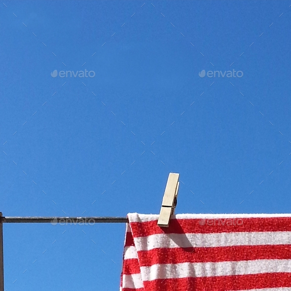 clothes hanging out to dry on clothes line against clear blue sky with space for text