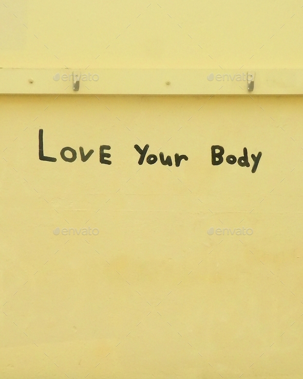 Love your body,Positive body image message handwrtten on yellow wall