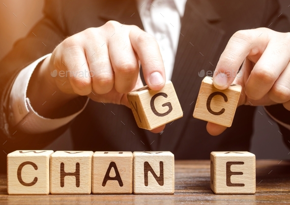 Businessman holding wooden blocks with the word Change to Chance