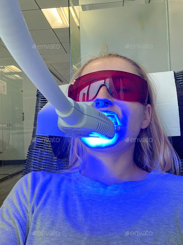 Woman getting her teeth whitened at the dental clinic