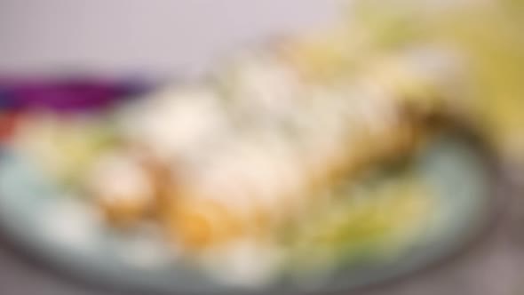 Mexican corn on the cob Elote garnished with fresh cilantro on serving plate. alt