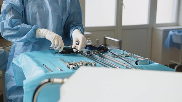 A Table of Medical Tools are Placed Upon a Table in Preparation for Robotic alt