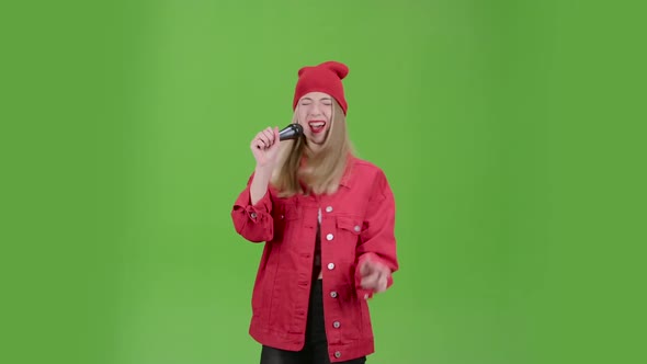 Singer Performs Popular Songs in the Microphone on Stage. Green Screen alt