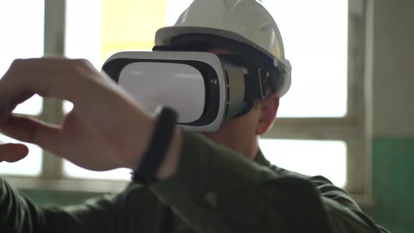 An Engineer Wearing Virtual Reality Glasses Moves Digital Objects with His Hands