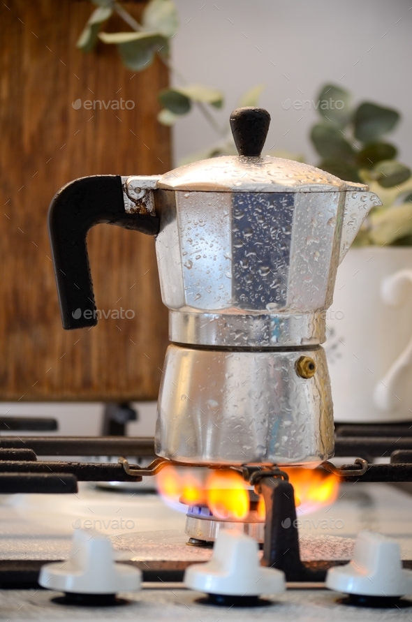 the process of making coffee in a coffee maker on gas. steamed coffee
