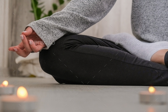 Close-up. Woman doing yoga exercise at home. Mindfulness meditation. Relax breathe easy pose gym hea