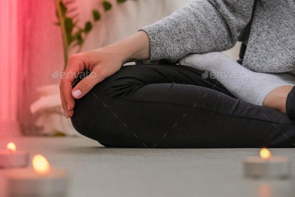 Close-up. Woman doing yoga exercise at home. Mindfulness meditation. Relax breathe easy pose gym hea