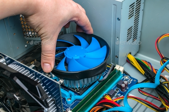 Computer wizard changes the cooling system of the processor on the computer motherboard - Stock Photo - Images