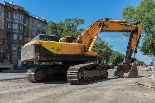Working, tracked equipment for digging trenches and removing road surfaces - Stock Photo - Images