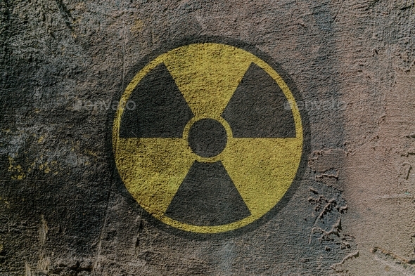 Sign of radioactive danger depicted on a concrete wall - Stock Photo - Images