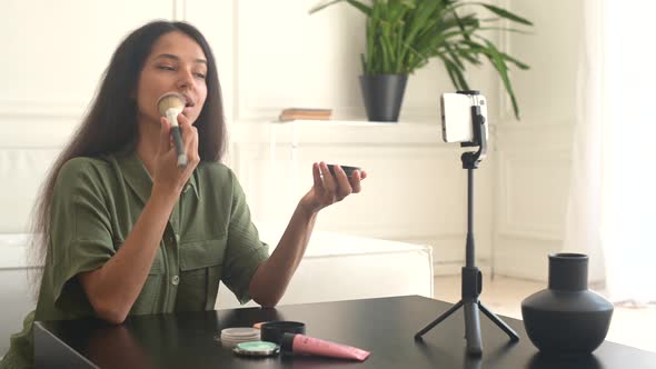 Charming Glamorous Indian Woman Beauty Vlogger Doing Makeup in Front of Smartphone