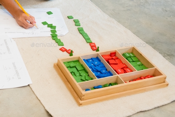 Colorful tiles of a Montessori math lesson, the stamp game for elementary students.