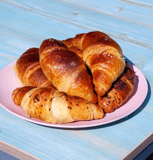 Plate with croissants for breakfast. Appetizing croissant - baking food for dessert.