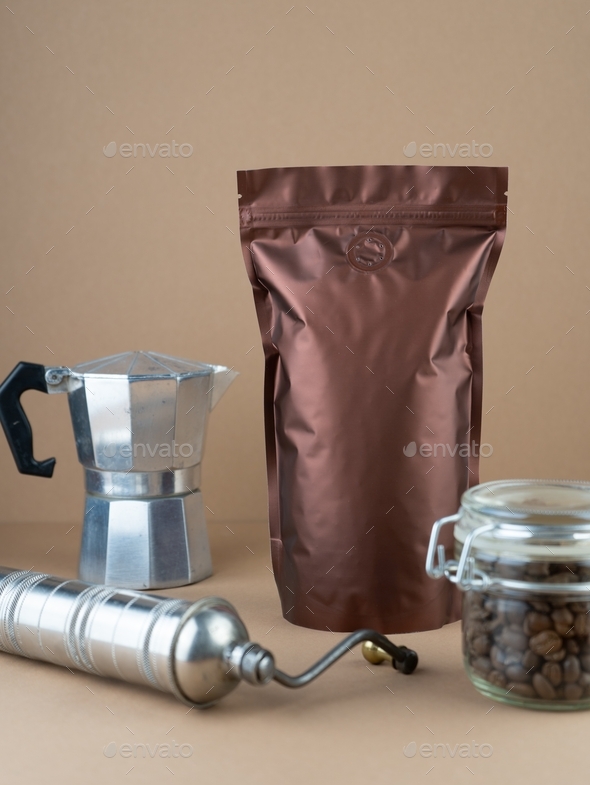 Packing coffee in a vacuum bag. Grain coffee, coffee maker and coffee grinder.