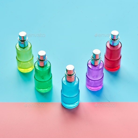 Flat Lay of cosmetic spray bottles on pink and sky blue background