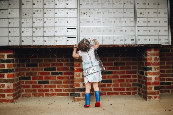 Child checking mailbox in an apartment complex