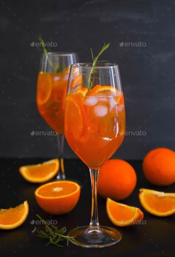 Aperol spritz, orange juice summer drink prosecco, soda and orange