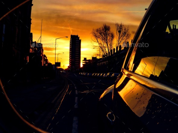 Sunset in the wing mirror of a car