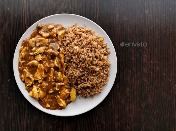 chinese-chicken-curry-with-egg-fried-rice-on-a-plate-stock-photo-by