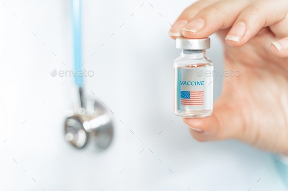 Vial with new usa, american vaccine for covid-19 coronavirus, flu, infectious diseases. Hand of doct