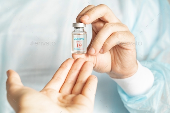Vial with new usa, american vaccine for covid-19 coronavirus, flu, infectious diseases. Hand reaches