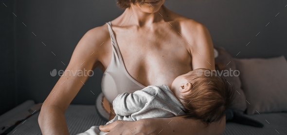 Mother is breast-feeding a newborn baby. Little baby girl breast feeding  Stock Photo