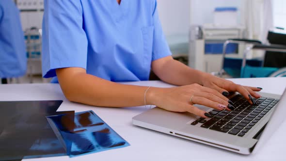 Close Up of Medical Woman Nurse Writing Results of Patient Radiography alt