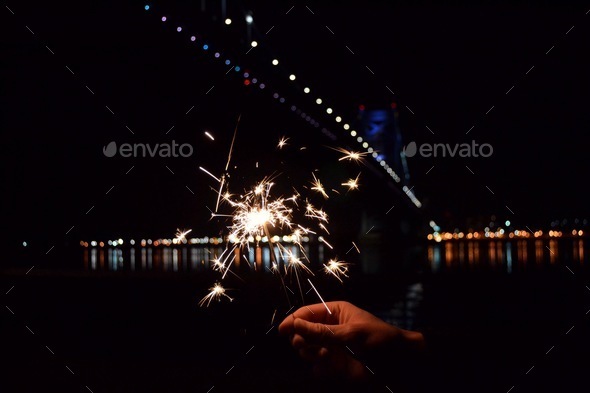 Sparklers by the water  - Stock Photo - Images