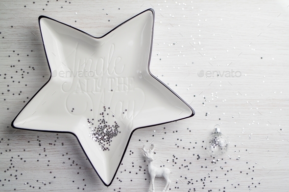 White star with text and silver glitter with Christmas decorations on the white background  - Stock Photo - Images