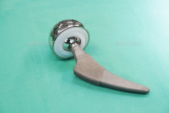 hip replacement prosthesis or prosthetic implant on green surgical drape