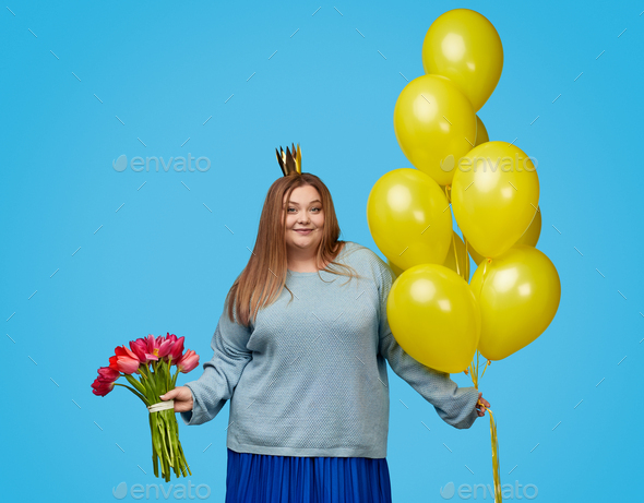 Cute plump woman with balloons and bouquet