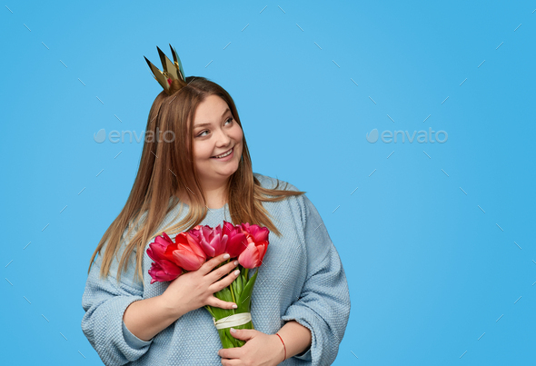 Plus size woman with flowers looking away
