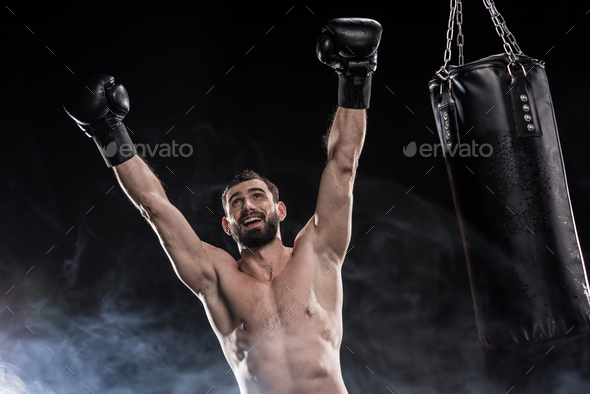 Happy Young Boxer Celebrating His Victory Raising Hands In Gloves ...