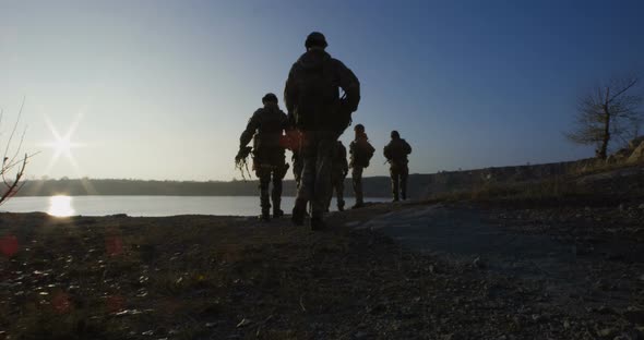 Equipped and Armed Soldiers Walking in Single File alt