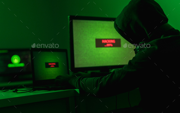 Anonymous hacker attacking database - Stock Photo - Images