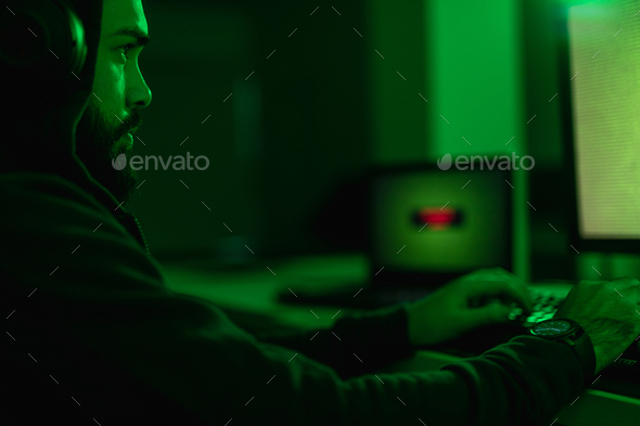Serious man hacking database - Stock Photo - Images