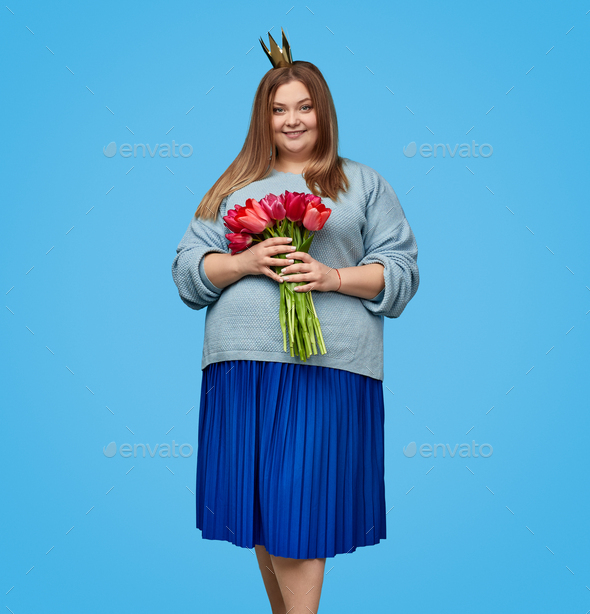 Plump lady with tulips looking at camera