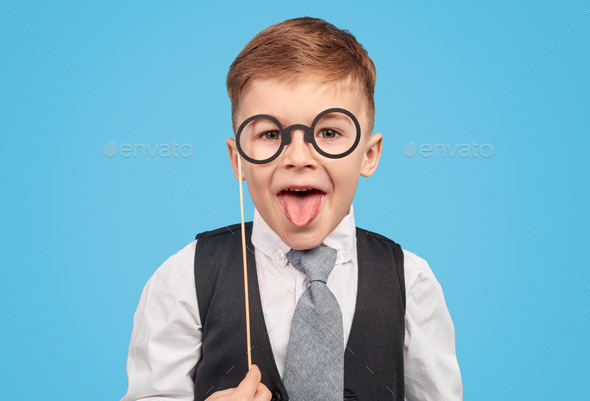 Boy in glasses showing tongue Stock Photo by kegfire | PhotoDune