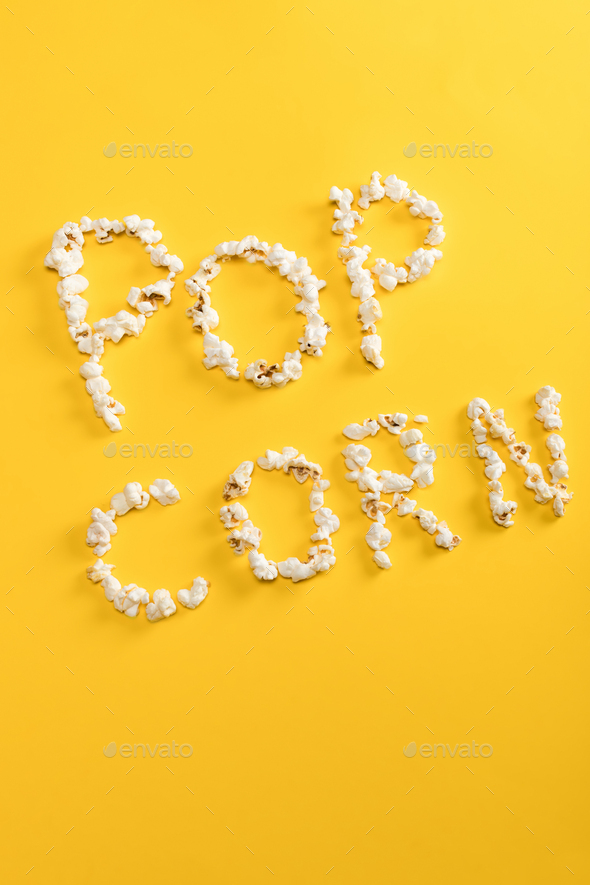 Top view of Pop corn lettering made from popcorn kernels on yellow