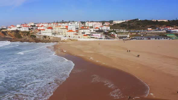Aerial Drone View of Sandy Beach at Lisbon, Portugal at Praia das Macas, a Beautiful Coastal Town on alt