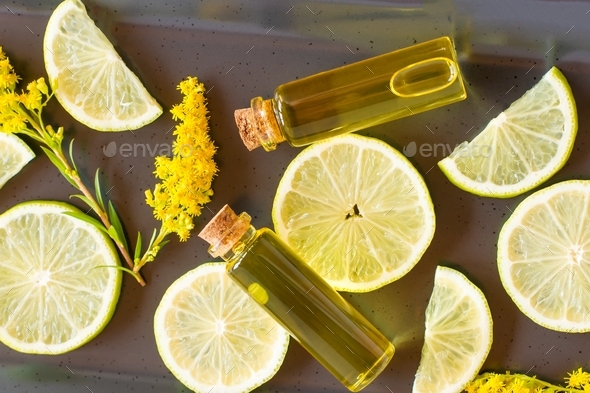 cosmetic oil from citrus frkt in a bottle with a pipette on a black background