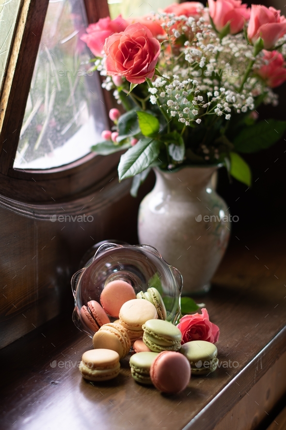 boucket with flowers and macaroons, pink roses, colorful macaroons, still life