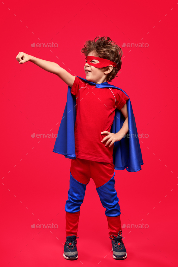 Little superhero in courageous pose