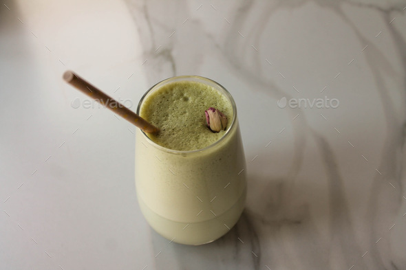 Glass of lavender Matcha with a straw. Green tea with coconut milk. Japanese green tea.