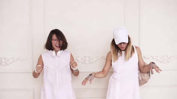 Two Sexy Girl Friends in White Dresses Dancing Off Enjoying Spending Time Together alt