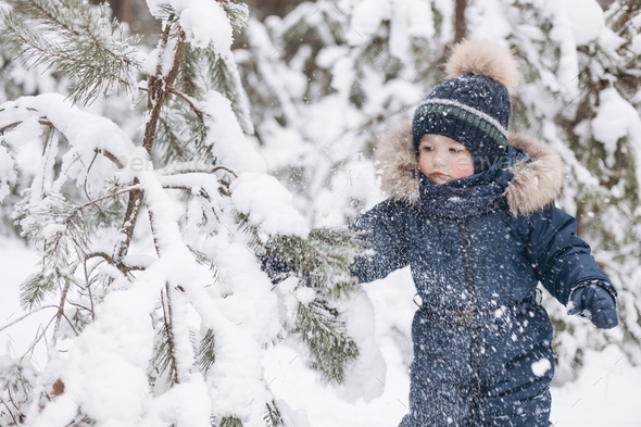 Boy In A Cold Winter Day Outdoors In Warm Clothes Stock Photo