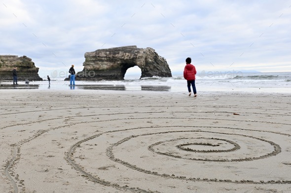 Spiral drawing on the sand at the beach