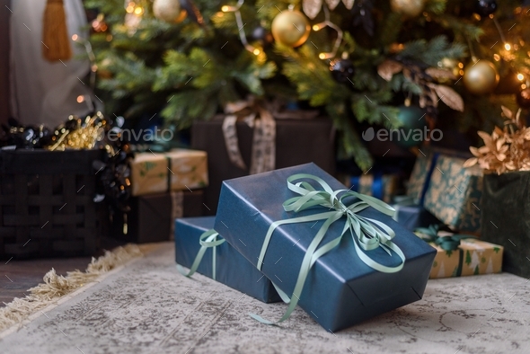 Wrapped gift boxes under Christmas tree - Stock Photo - Images